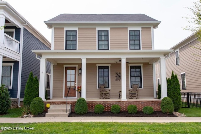 view of front of property featuring a porch, a ceiling fan, and fence