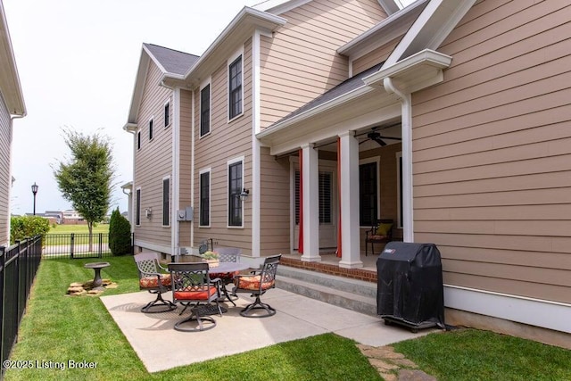 back of property featuring a ceiling fan, a yard, a patio area, and fence