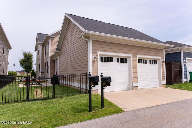 view of property exterior featuring concrete driveway, a yard, fence, and a garage