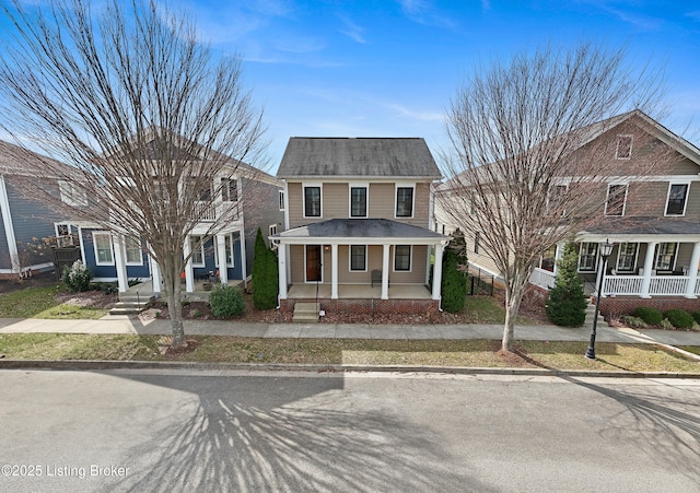 view of front of property featuring covered porch and roof with shingles