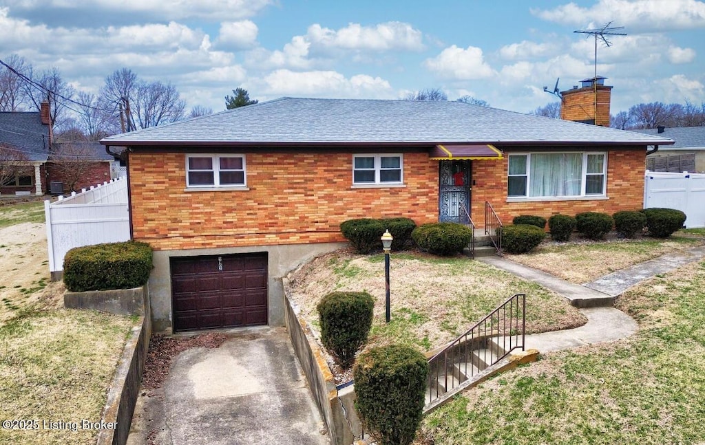 ranch-style home with brick siding, a chimney, a garage, and fence