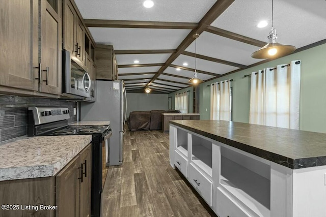 kitchen featuring decorative backsplash, dark wood-type flooring, appliances with stainless steel finishes, dark countertops, and open floor plan