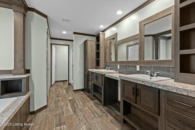 bathroom featuring visible vents, backsplash, decorative columns, and wood finished floors