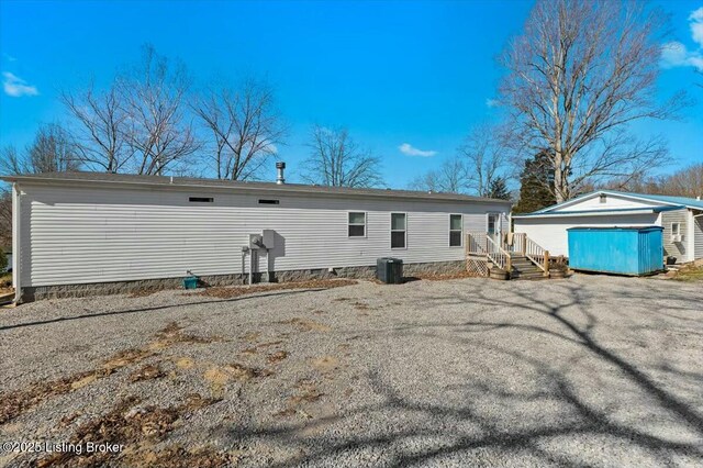 rear view of house with an outbuilding and central AC