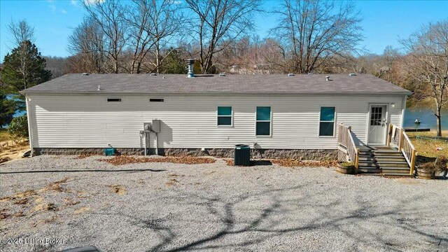 rear view of property with a shingled roof