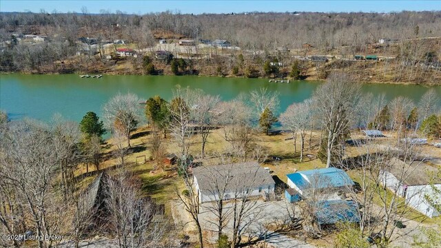 birds eye view of property with a view of trees and a water view