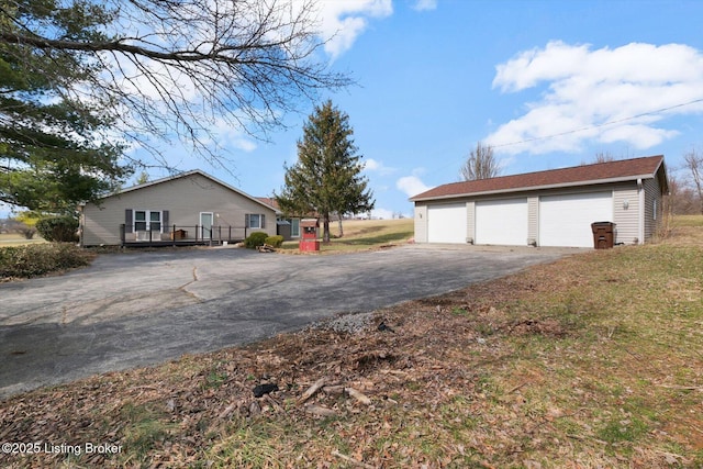 exterior space featuring a garage and an outbuilding