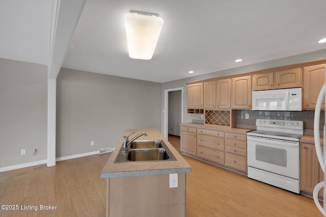 kitchen with decorative backsplash, white appliances, light brown cabinets, and a sink