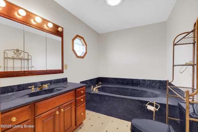 bathroom with tile patterned floors, vanity, and a garden tub