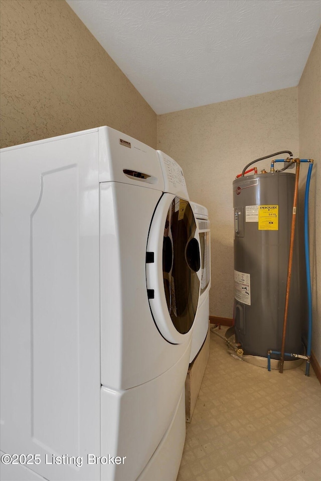 laundry area featuring washer and dryer, laundry area, light floors, and water heater