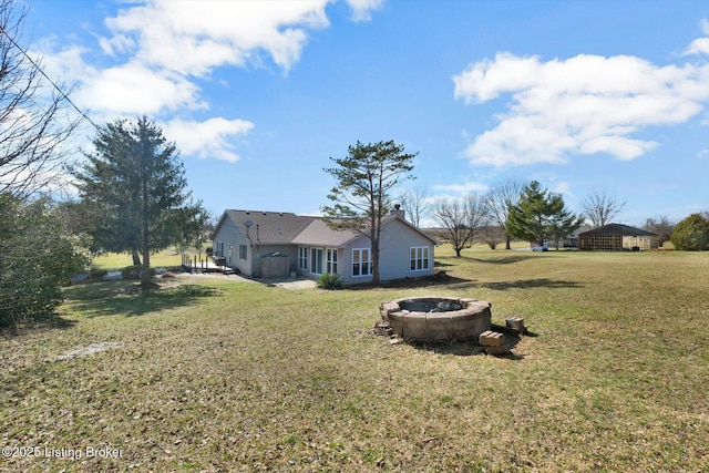 view of yard with a detached carport and an outdoor fire pit