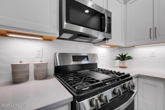 kitchen featuring tasteful backsplash, appliances with stainless steel finishes, and light countertops