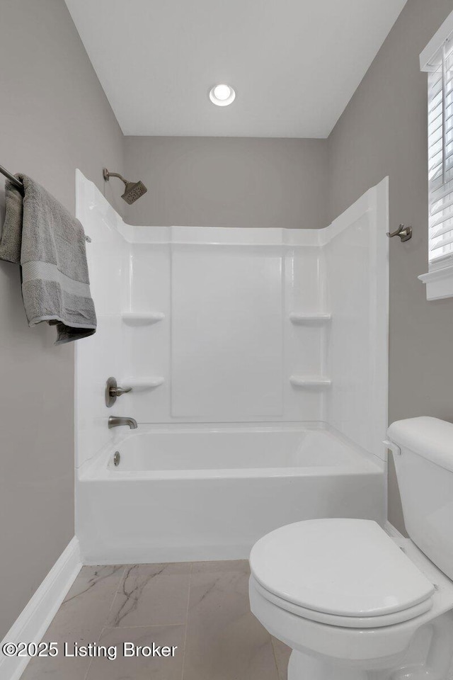 full bathroom featuring toilet, marble finish floor, recessed lighting, baseboards, and shower / bathtub combination