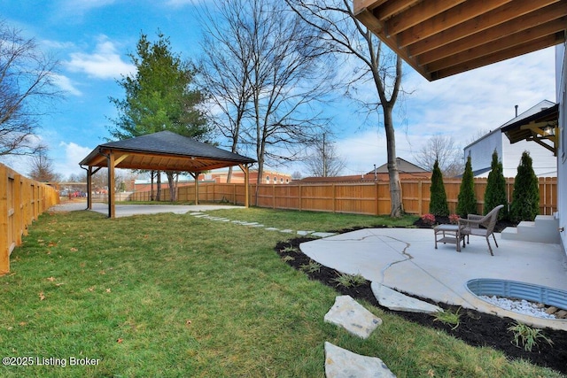 view of yard featuring a gazebo, a patio area, and a fenced backyard