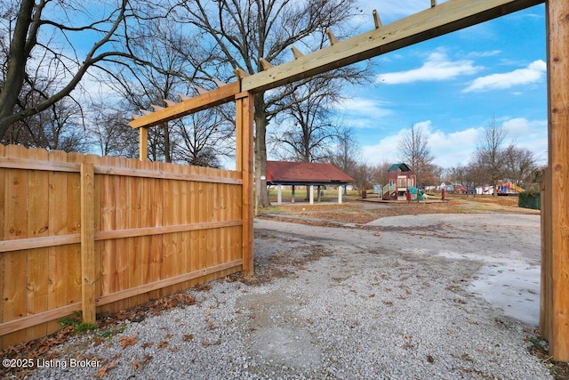 view of yard with a playground and fence