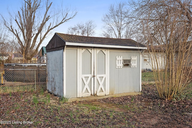 view of shed featuring fence