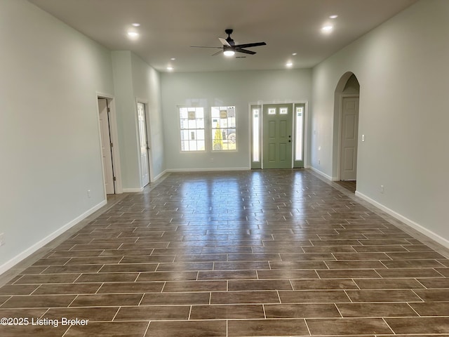 interior space featuring recessed lighting, arched walkways, baseboards, ceiling fan, and wood tiled floor