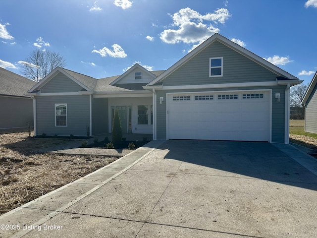 ranch-style house with covered porch, driveway, and a garage