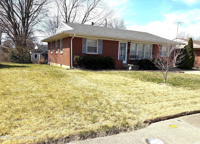 ranch-style home featuring a front lawn, brick siding, and a shingled roof