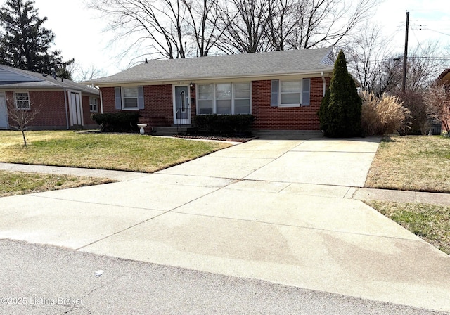 ranch-style house with brick siding, a front lawn, and driveway