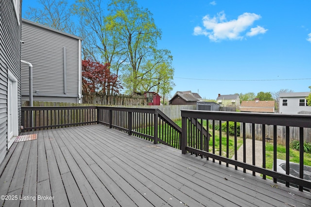 wooden terrace featuring a residential view and fence