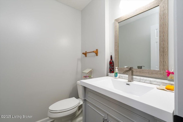 bathroom featuring toilet and vanity