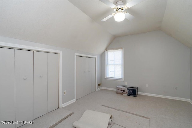 additional living space with baseboards, lofted ceiling, carpet, and a ceiling fan