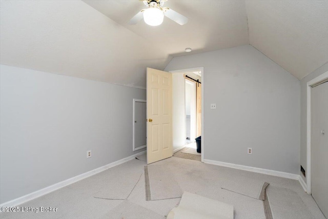 bonus room with baseboards, light carpet, a ceiling fan, and vaulted ceiling