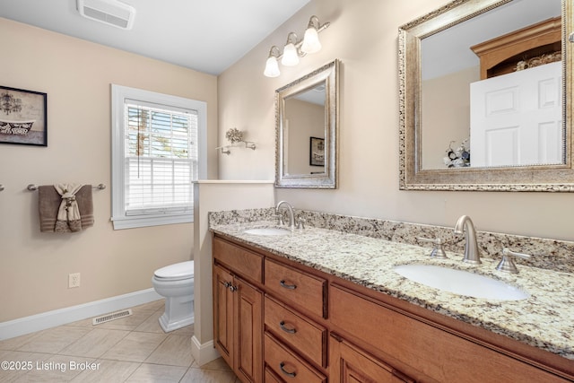 bathroom with a sink, visible vents, and toilet