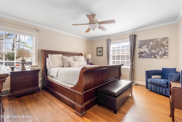 bedroom featuring a ceiling fan, crown molding, baseboards, and hardwood / wood-style floors