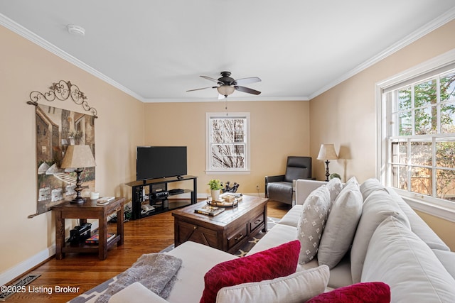 living area with baseboards, wood finished floors, a ceiling fan, and ornamental molding