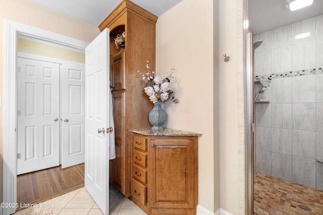 bathroom featuring tile patterned floors and tiled shower