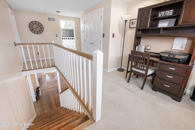 office with visible vents, light colored carpet, and baseboards