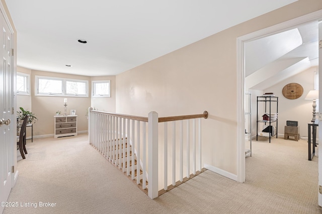 hall featuring an upstairs landing, carpet flooring, recessed lighting, and baseboards