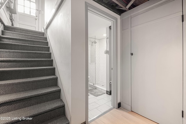 stairs featuring wood finished floors