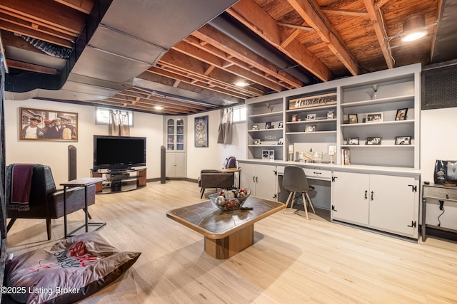 living area featuring built in desk and light wood finished floors