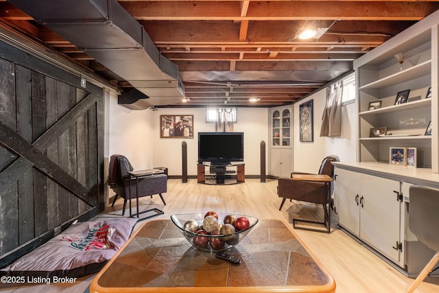 below grade area featuring baseboards and light wood finished floors