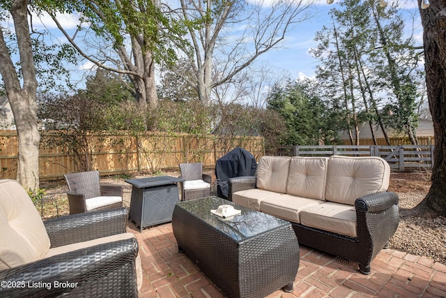 view of patio with grilling area, a fenced backyard, and an outdoor hangout area