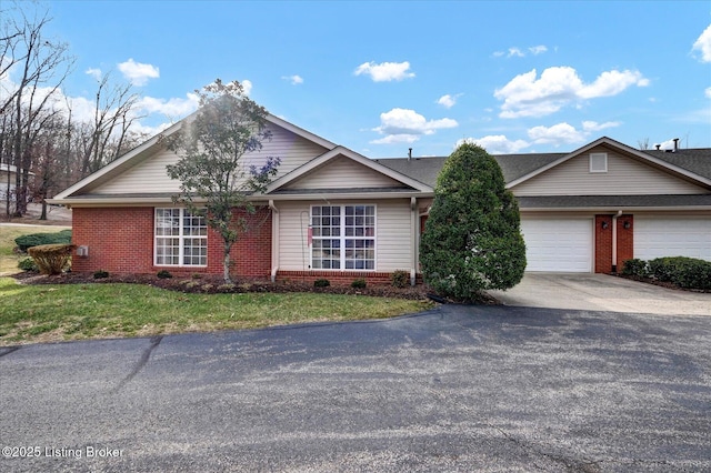 ranch-style home featuring brick siding, driveway, an attached garage, and a front yard