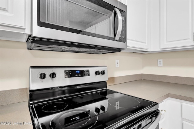 kitchen featuring white cabinetry, stainless steel appliances, and light countertops