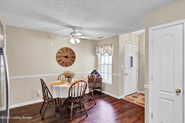 dining area featuring visible vents, a ceiling fan, a textured ceiling, wood finished floors, and baseboards