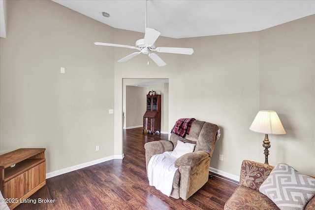 living area featuring a ceiling fan, wood finished floors, and baseboards