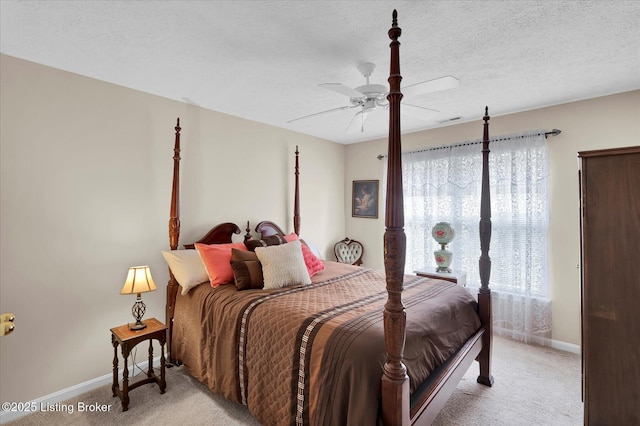 bedroom featuring light carpet, baseboards, visible vents, and a textured ceiling