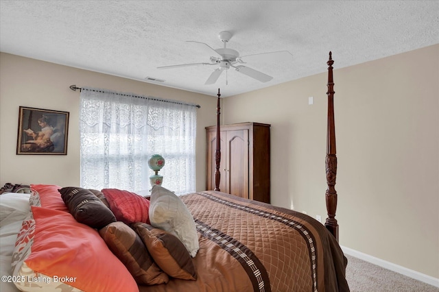 bedroom featuring carpet flooring, baseboards, visible vents, and a textured ceiling