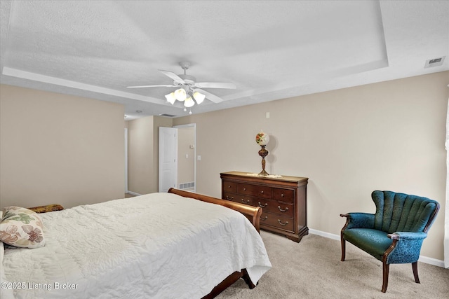 bedroom with visible vents, light carpet, baseboards, and ceiling fan