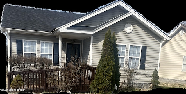 view of exterior entry with roof with shingles