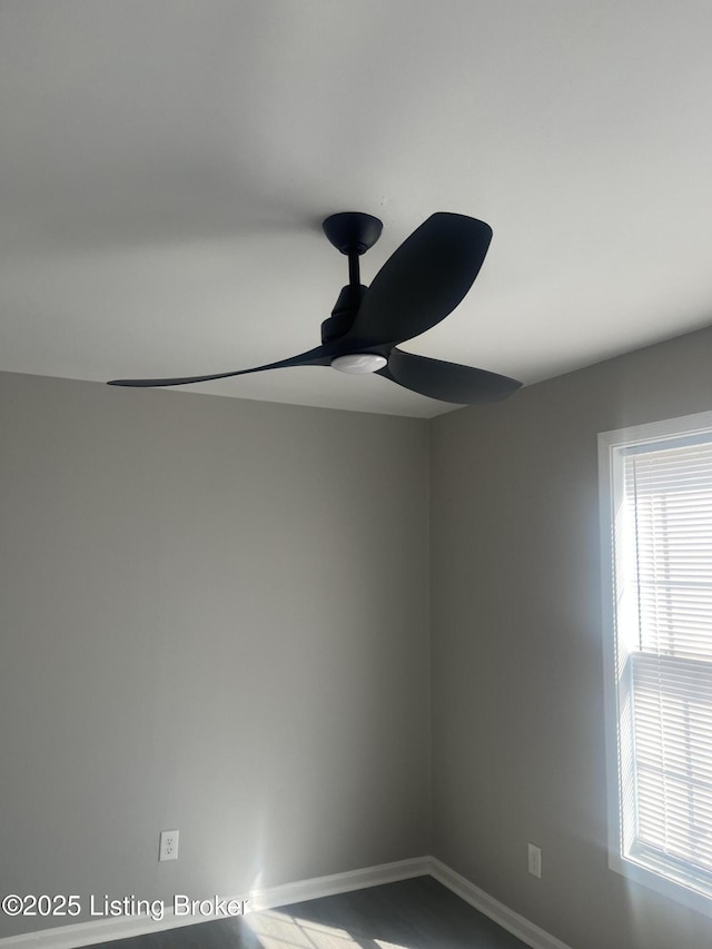 room details with baseboards and ceiling fan