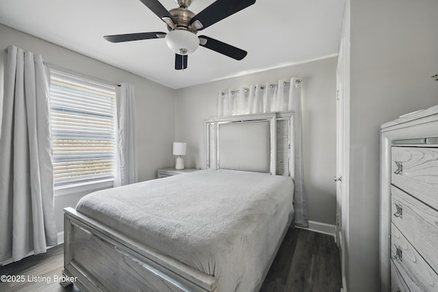 bedroom with baseboards, dark wood finished floors, and a ceiling fan