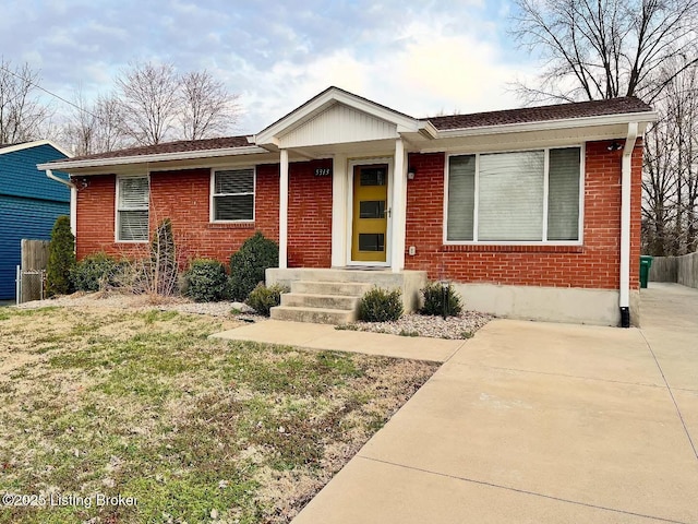 ranch-style house with fence and brick siding