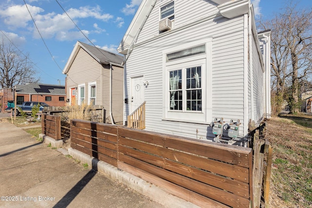 exterior space featuring cooling unit and fence